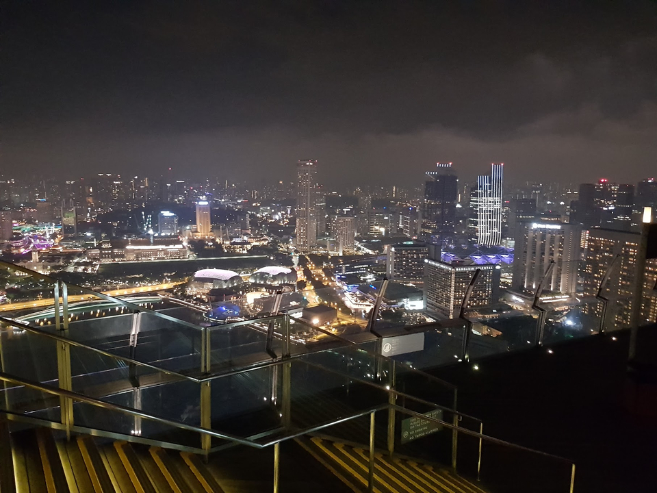 Paysage urbain de Singapour la nuit avec des gratte-ciel illuminés.