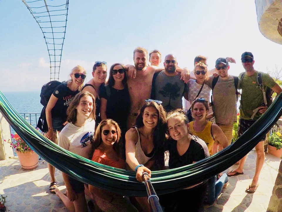 Groupe de personnes posant avec un hamac dans un environnement tropical.