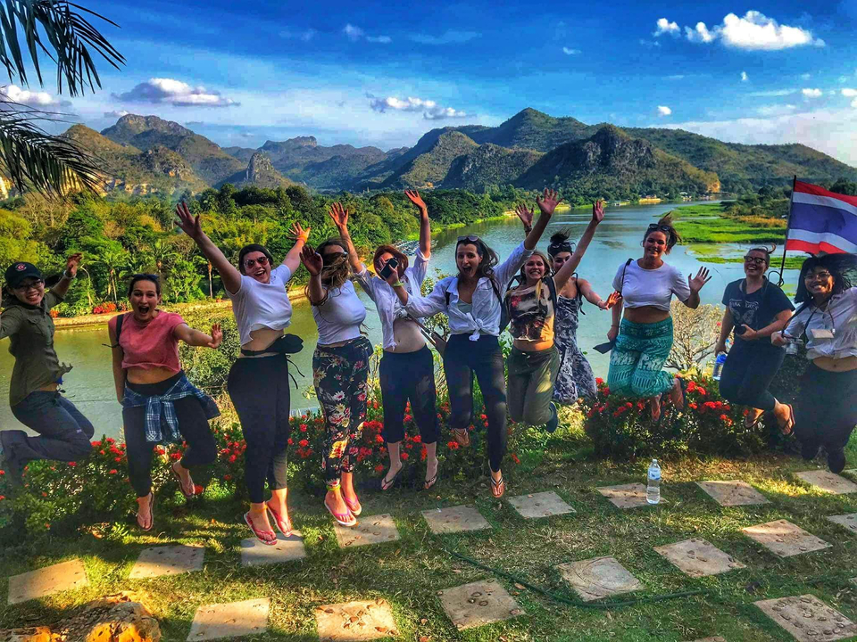 Group jumping with a scenic background.