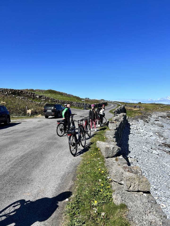 Cyclists on a road in a rural setting.