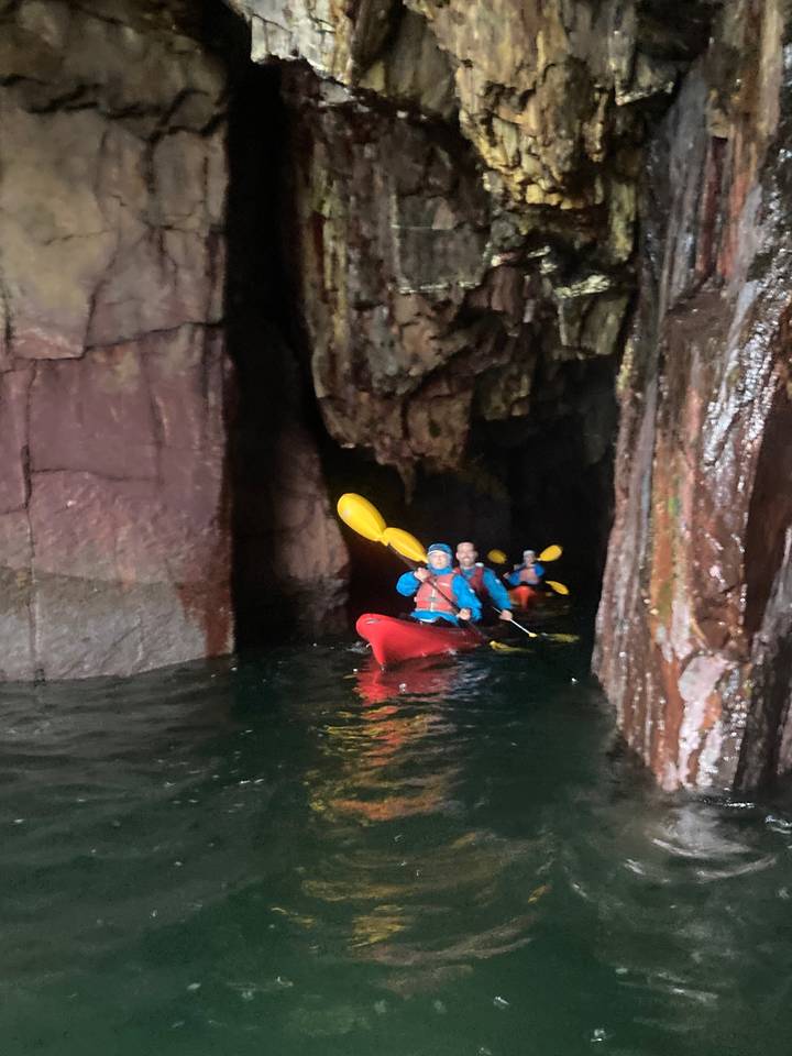 Group kayaking in a cave.