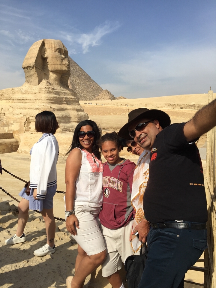 Famille posant devant le Sphinx près des pyramides.