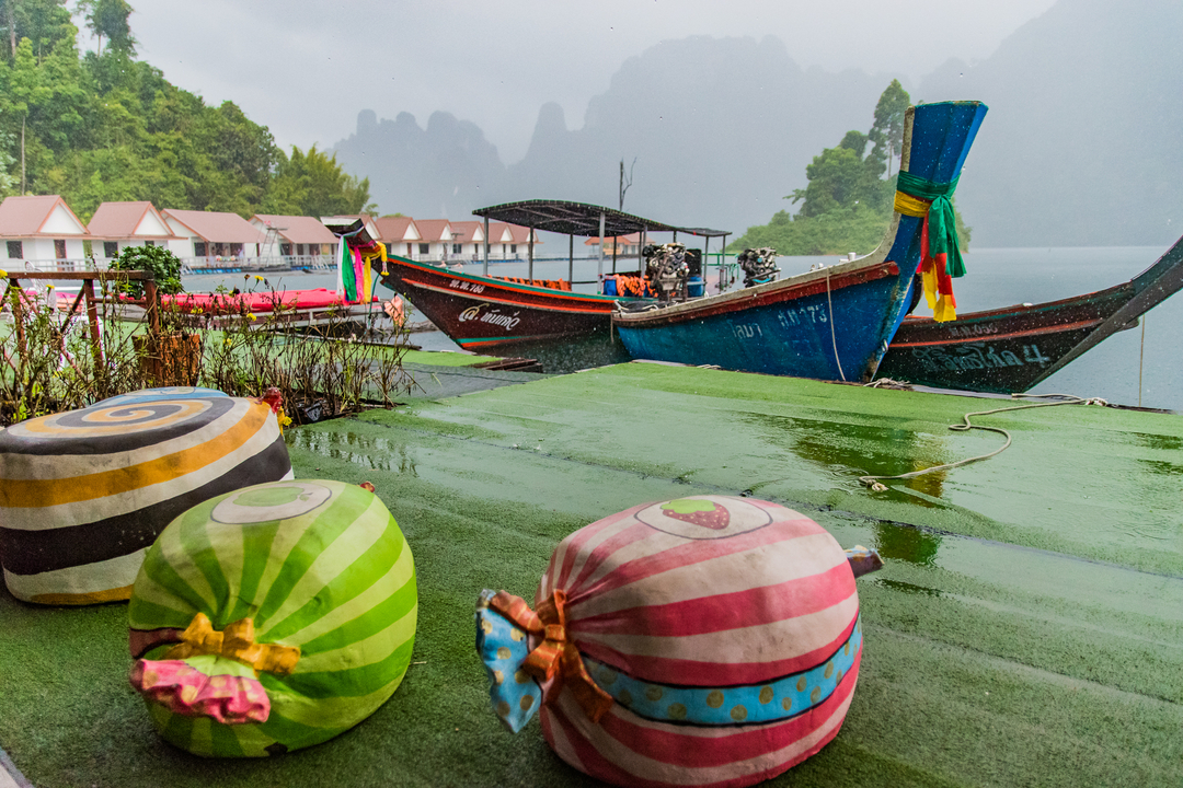 Boats at a dock in a rainy environment.