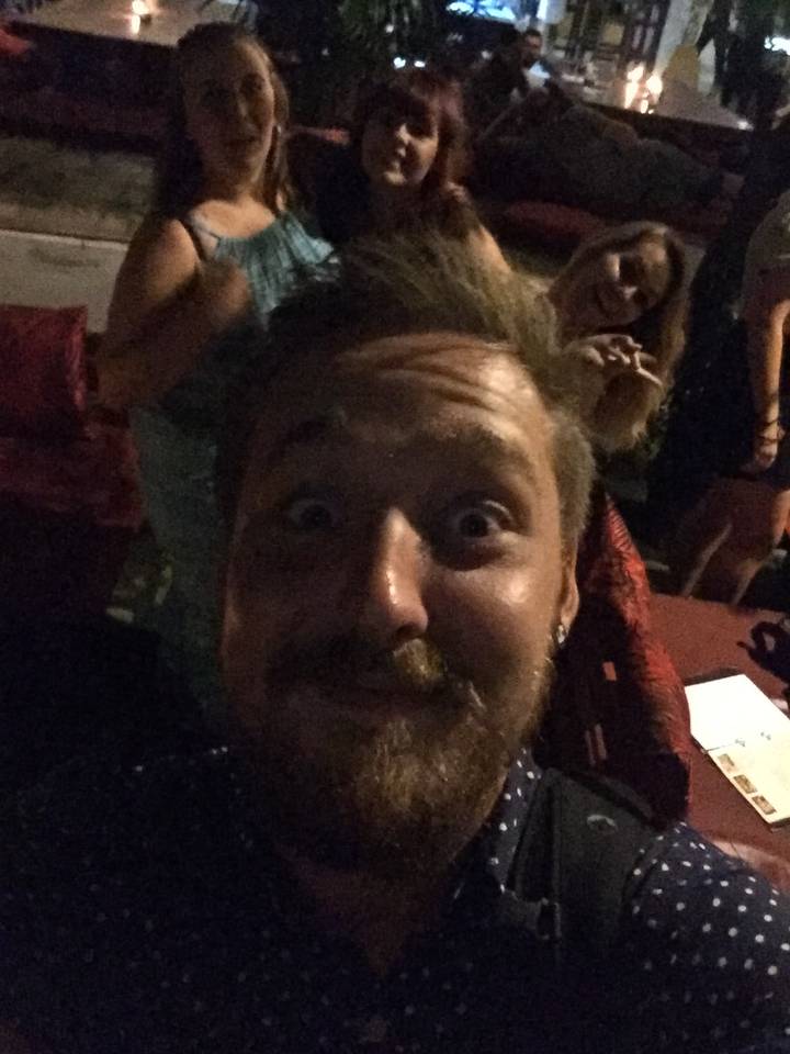 Group photo taken in a dark environment.