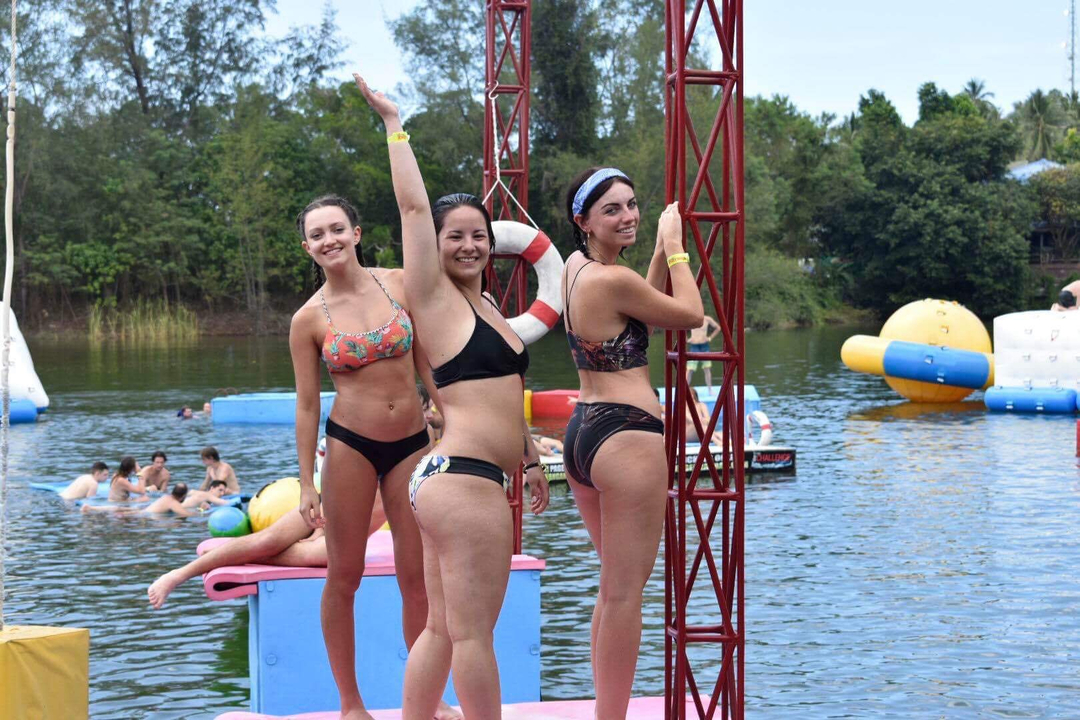 People posing at an inflatable water park.