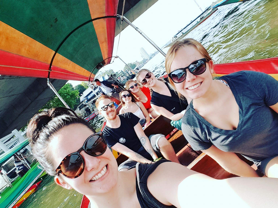 People seated on a boat enjoying a sunny day.