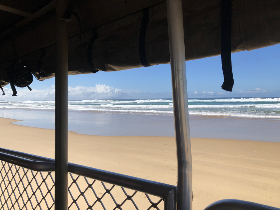 Beach view with waves crashing along the shore.