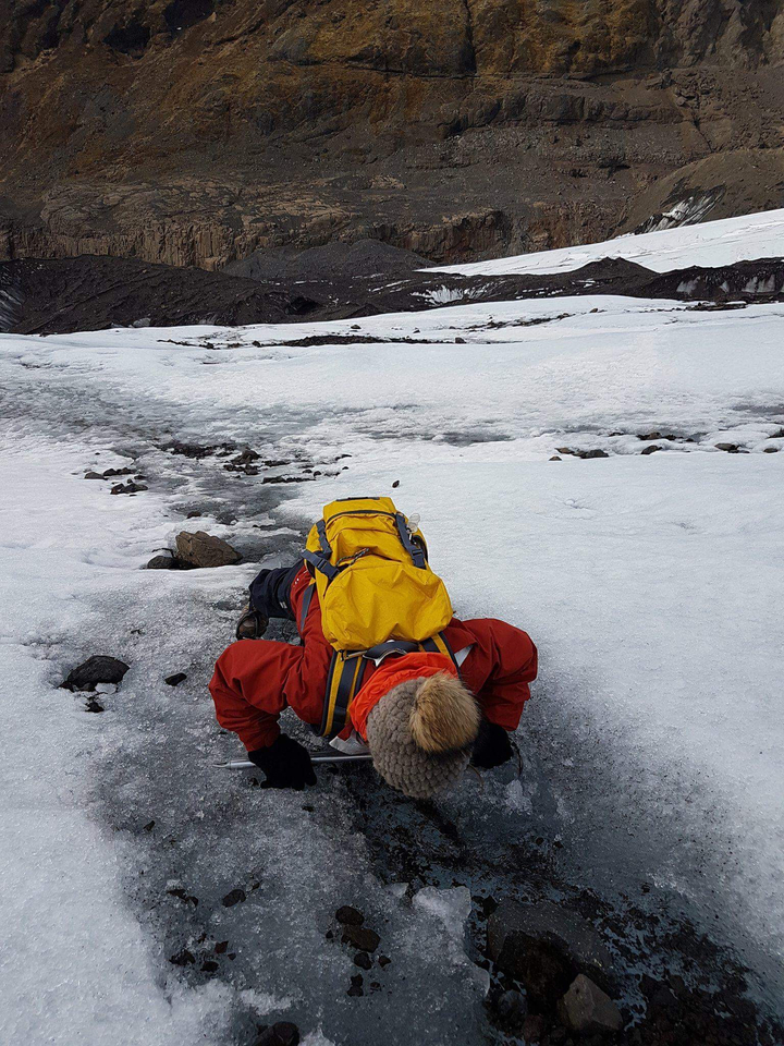Person lying on a snowy surface.