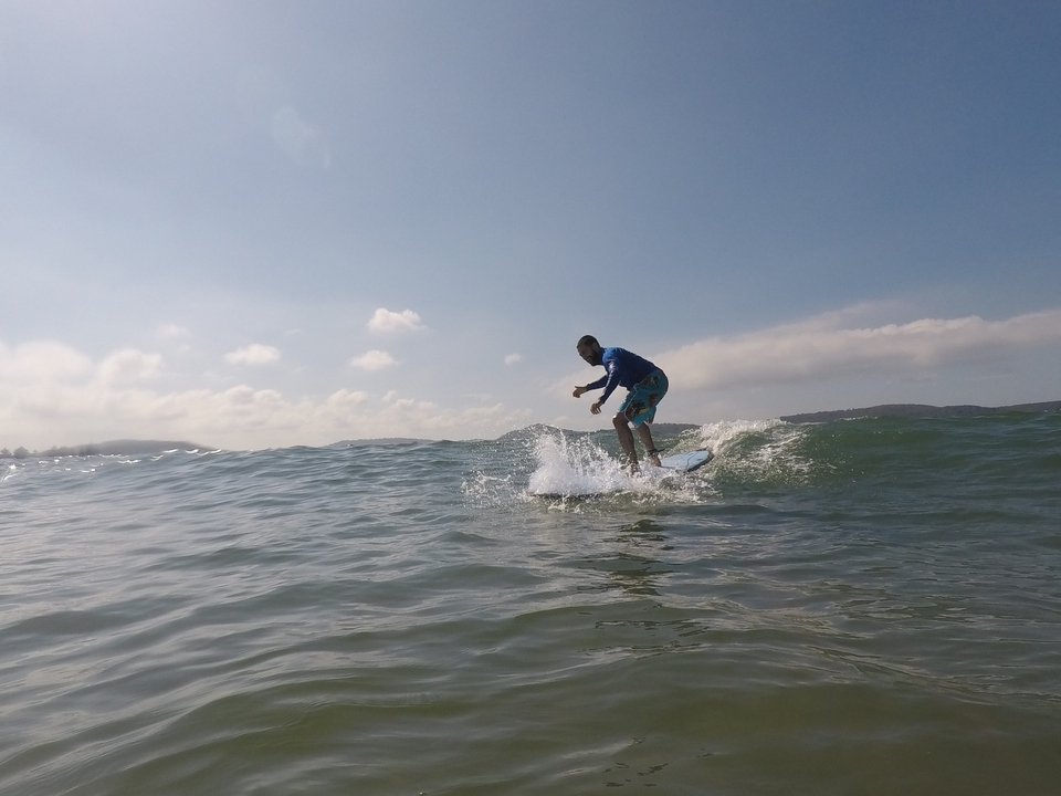 Person surfing on the ocean wave.