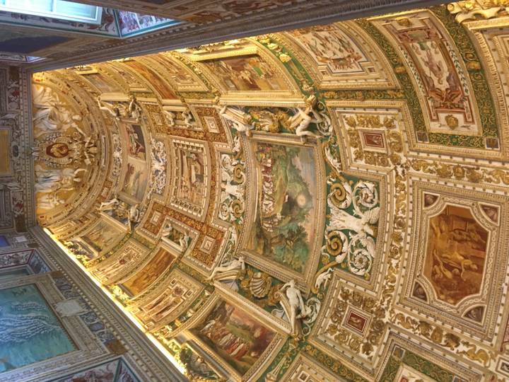 Plafond décoré avec des peintures et sculptures complexes.