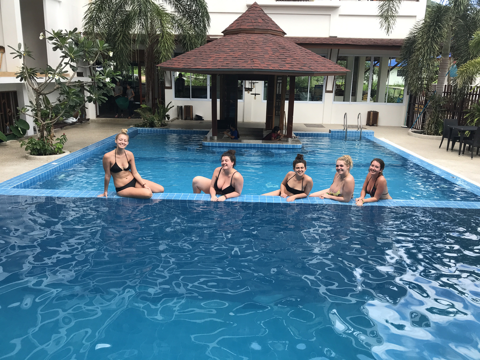 People relaxing in a swimming pool at a resort.