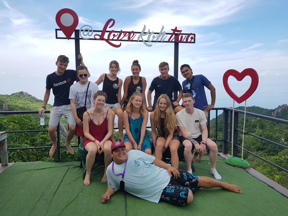 Large group photo at a viewpoint with signage.