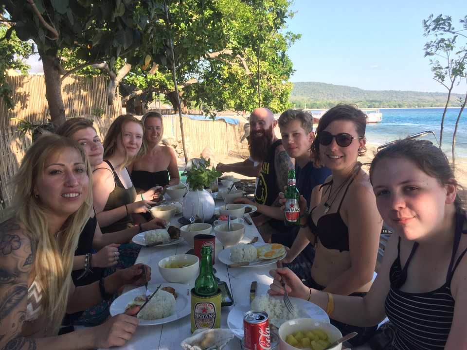 Group dining at a seaside location.