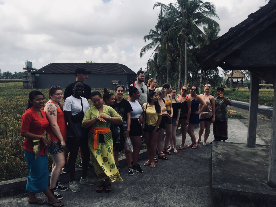 Group of tourists taking a tour in a tropical setting.