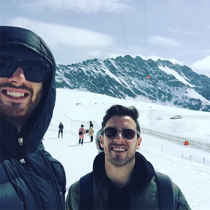 Two people taking a selfie on a snowy mountain.