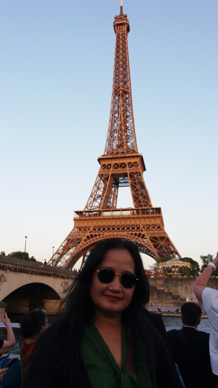 Tour Eiffel avec une personne partiellement visible au premier plan.