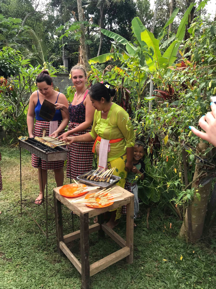 A group participating in a cooking class with a local.