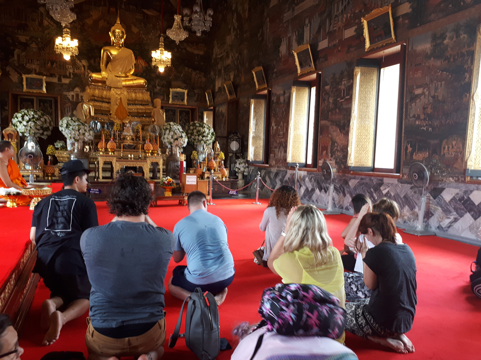 People praying inside a temple.