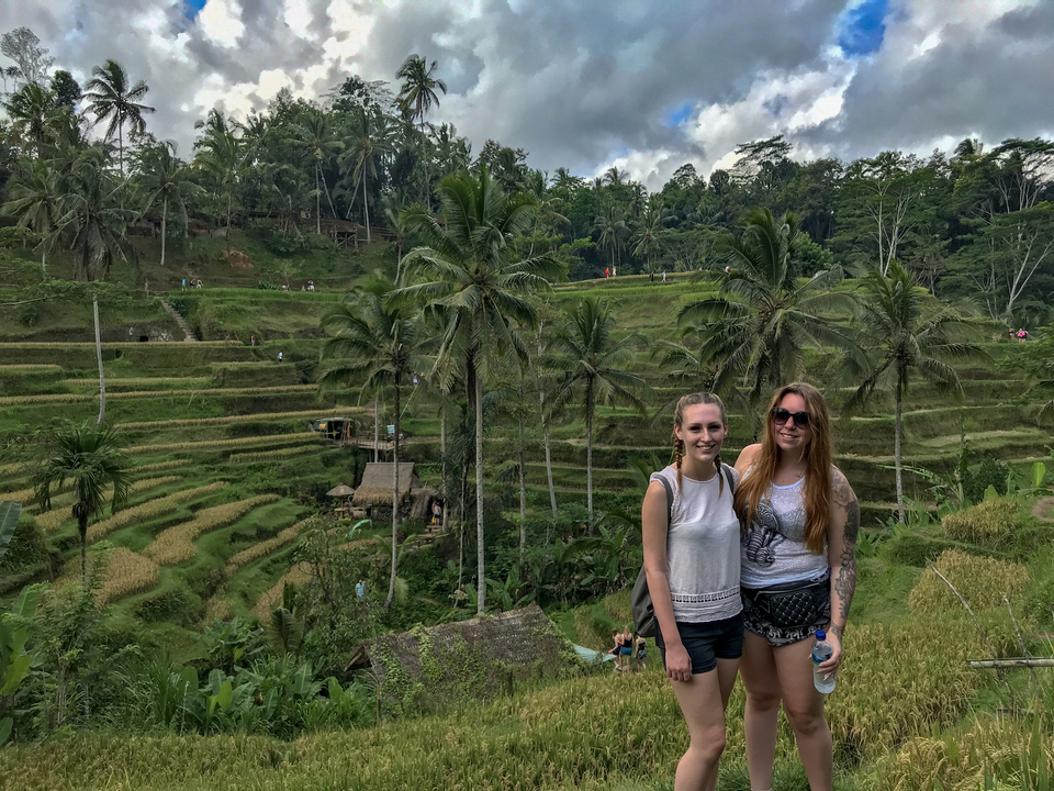 Two women posing at scenic rice terraces.