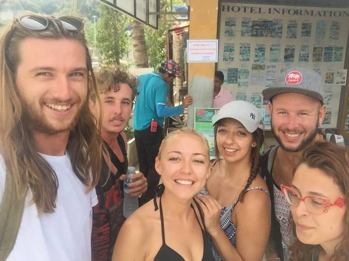 Group of friends posing for a selfie, image is upside-down.