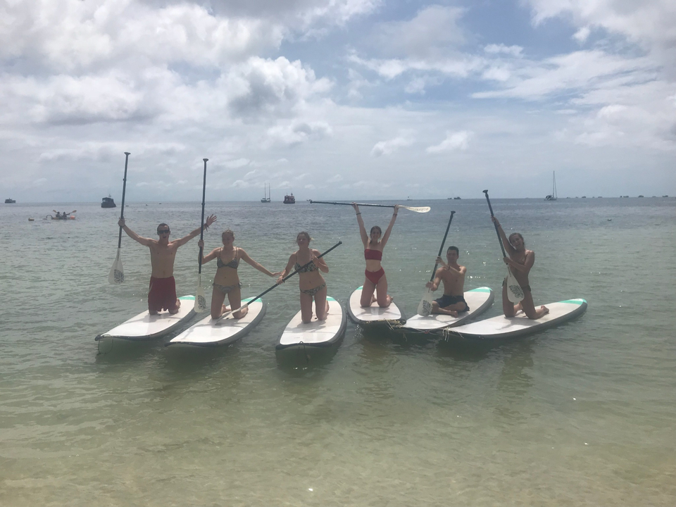 People paddleboarding on the ocean.