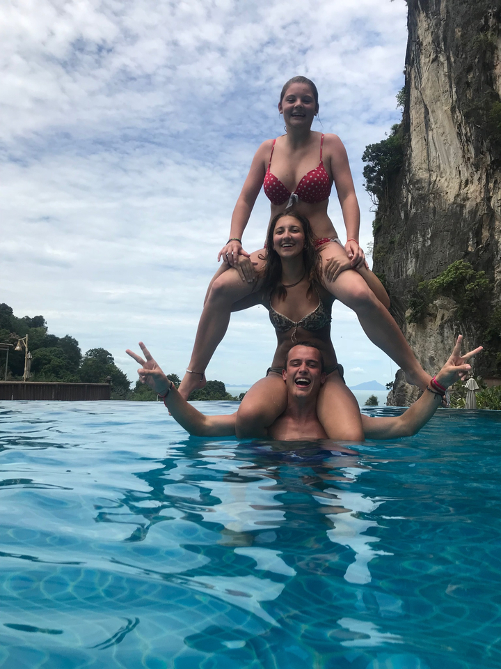 Two people playing in a pool while posing.