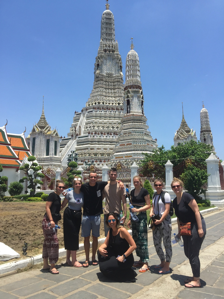Group standing in front of a grand temple.