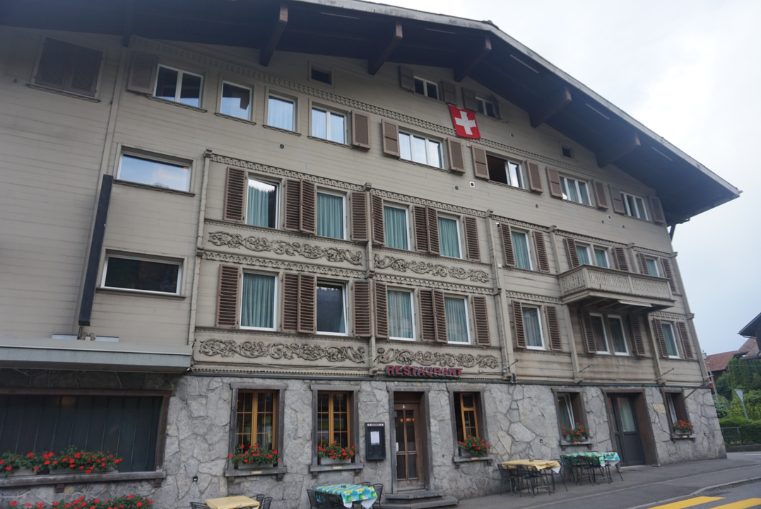 Historic building with Swiss flag on top.