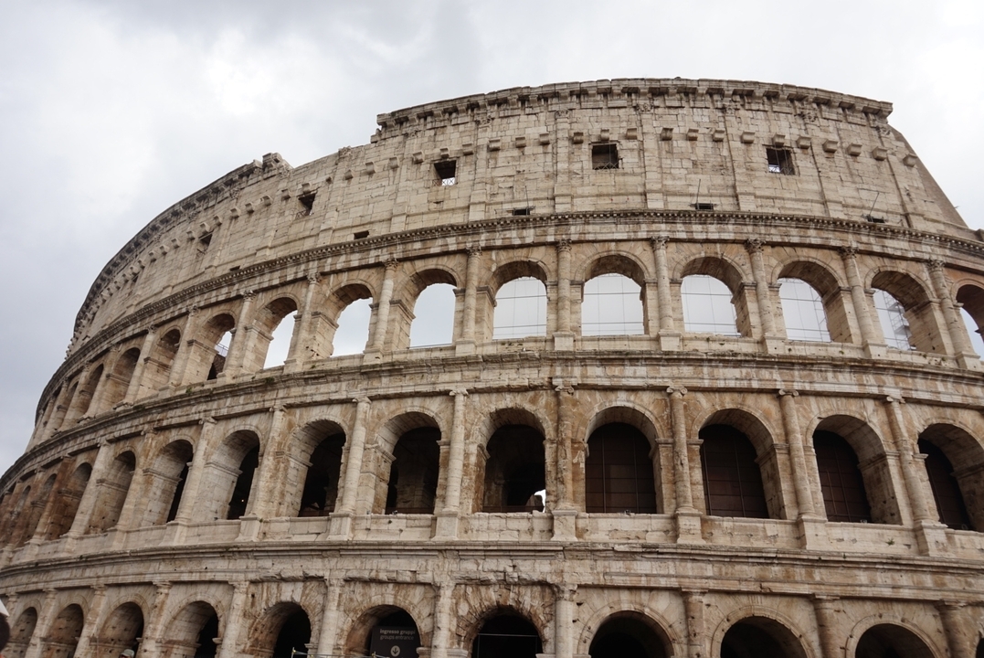 Iconic Colosseum in Rome with clear skies in the backdrop.