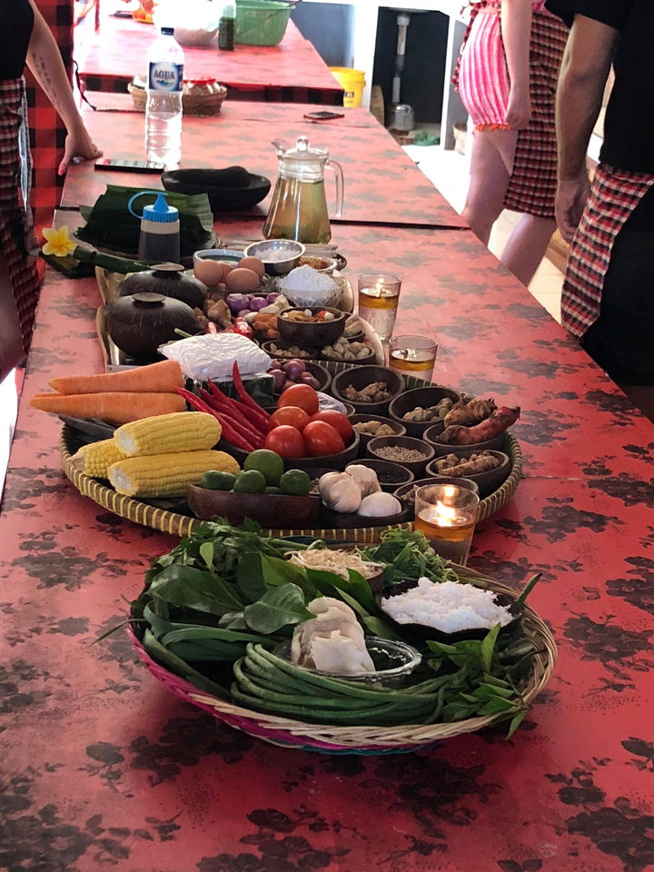 A table with an assortment of food ingredients including vegetables and spices.
