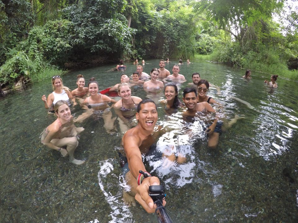 Group of people swimming in a natural pool.