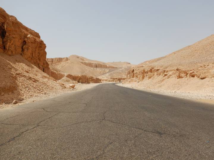Desert road through rocky landscape.