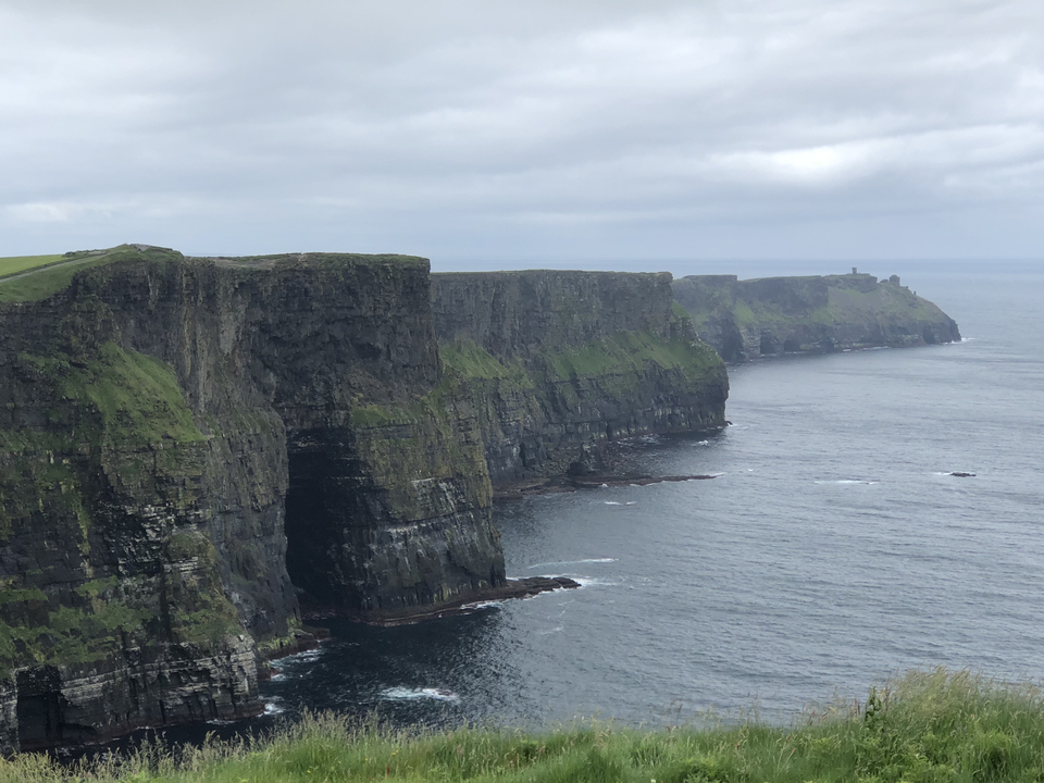 Panoramic view of Cliffs of Moher overlooking the ocean.