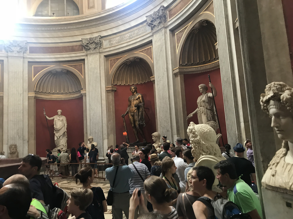 Large museum hall with statues around a circular room.