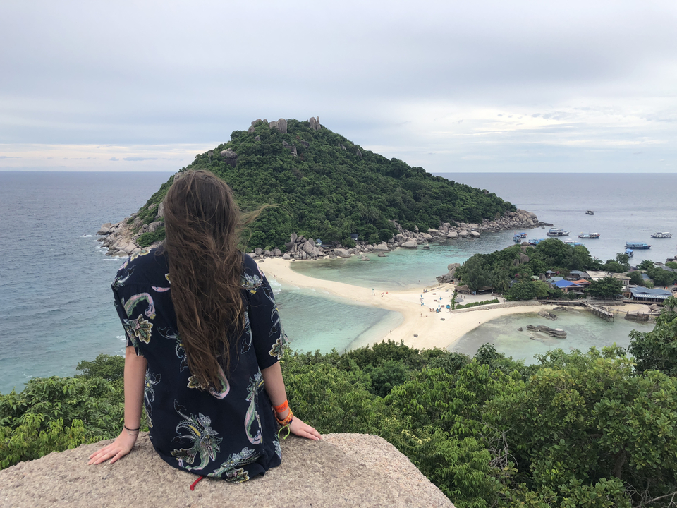 Woman overlooking a picturesque island beach.