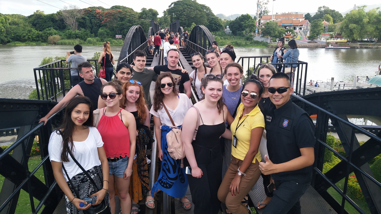 A group of people on a historic bridge.