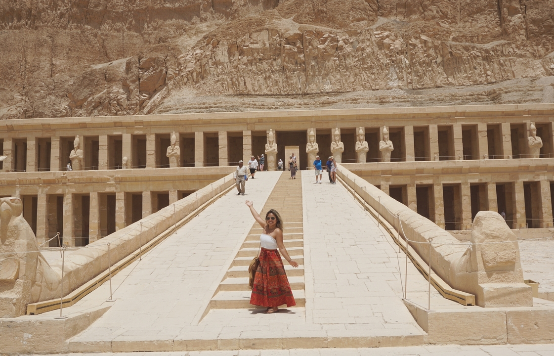Person posing at the Temple of Hatshepsut with grand staircases.