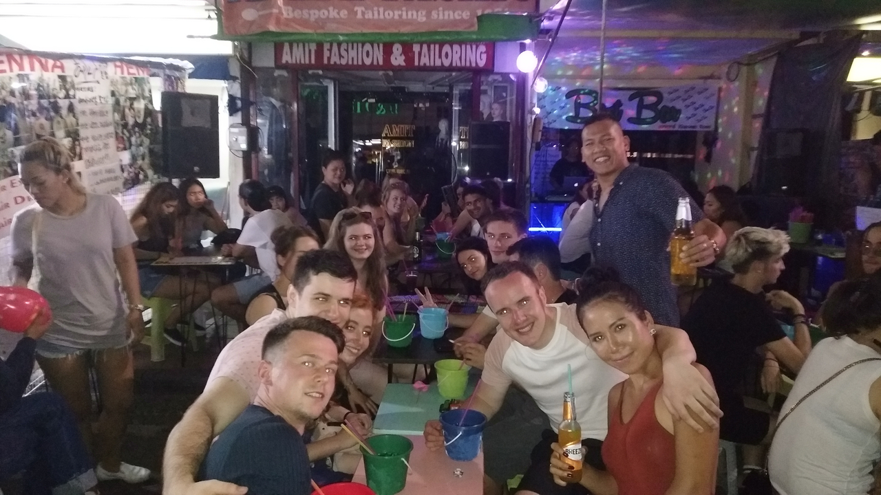 A large group of people socializing in a lively setting.