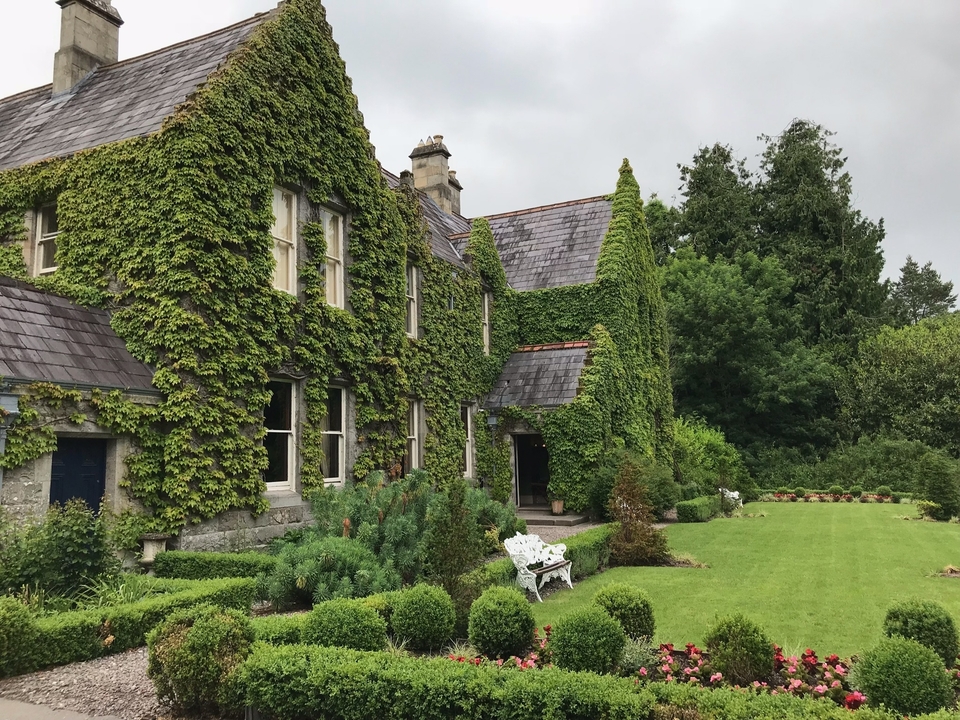 Ivy-covered house with garden.