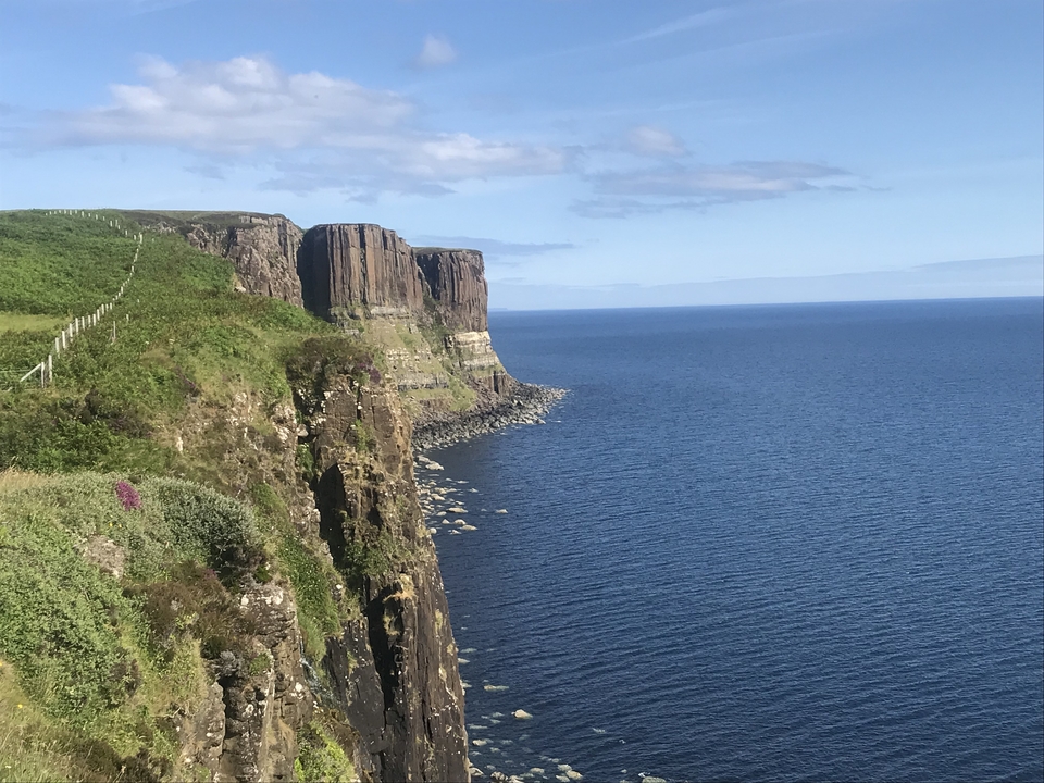 Vue sur l'océan à flanc de falaise et ciel dégagé.