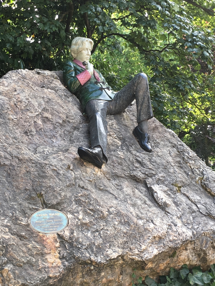 A statue resting on a rock.