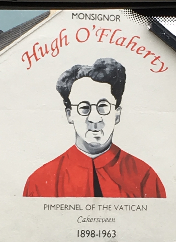 Peinture murale d'un homme avec des lunettes sur un mur.