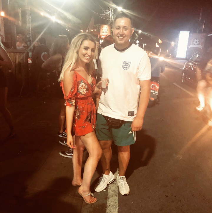 Man and woman posing at night.