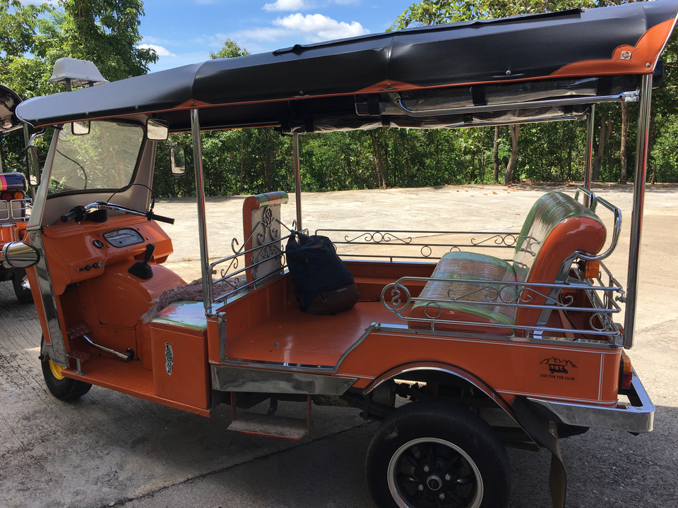 Un tuk-tuk vide garé dans une rue.