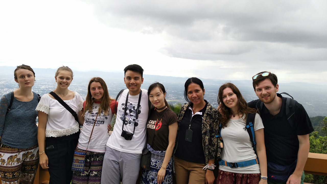 Group standing with a city view in the background.