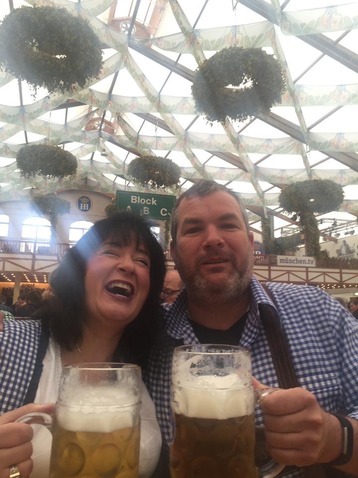 Un homme et une femme sourient à l'intérieur d'une structure en forme de tente.