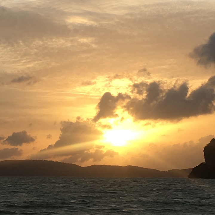 A sunset view with dramatic clouds and sunbeams.