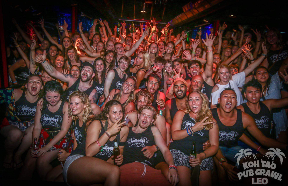 Crowded group photo at a lively indoor event.