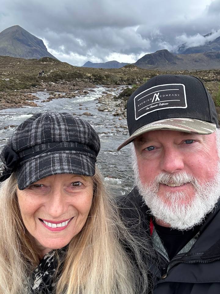 A couple taking a selfie in a mountainous area.