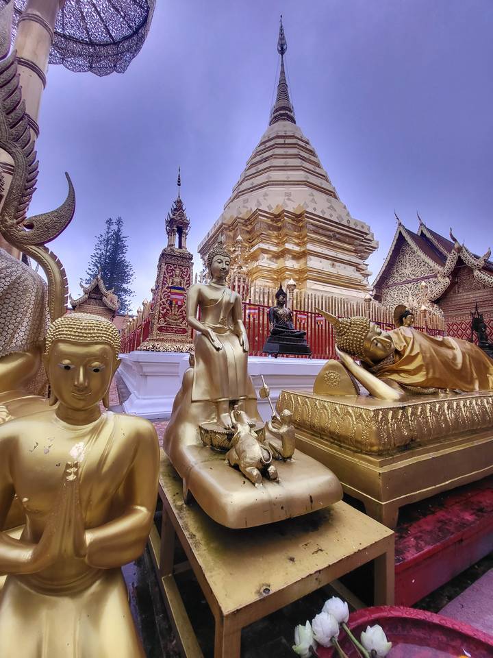 Golden temple structure with statues in the foreground.